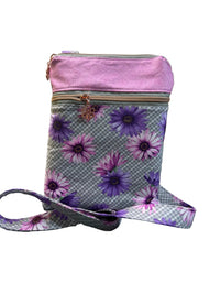 A small crossbody bag with a lavender purple top flap and a gray gingham body printed with purple and pink daisy flowers. The bag has a matching floral and gingham strap.