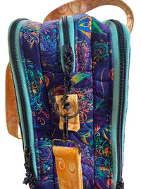 A close-up of a quilted briefcase with a vibrant multicolor paisley pattern in purple, teal, orange, and green, featuring orange handles and trim.