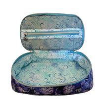 An open zippered cosmetic bag with a blue and purple swirl patterned exterior and lining.