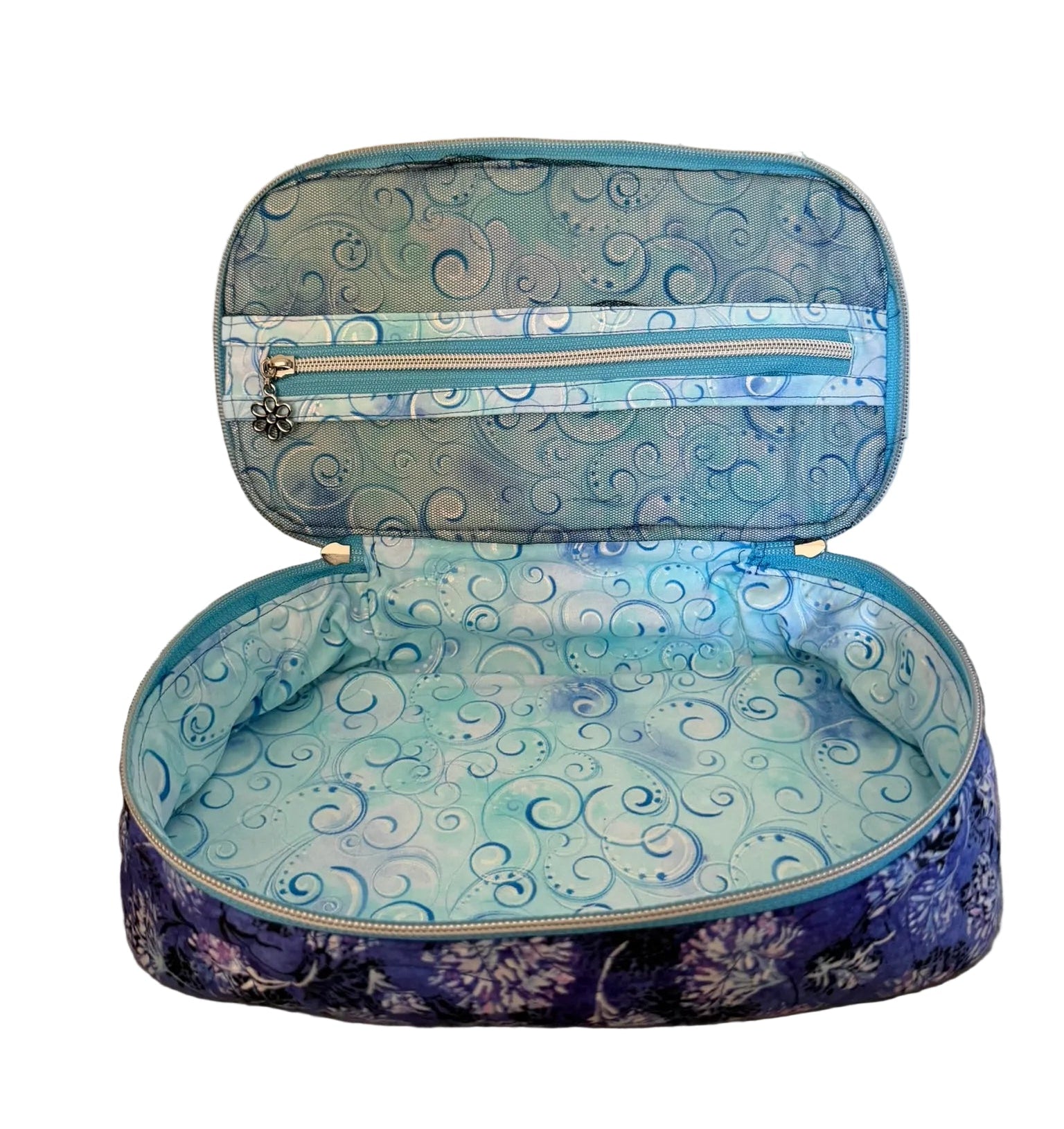 An open zippered cosmetic bag with a blue and purple swirl patterned exterior and lining.