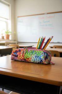 A colorful zippered pencil case with a vibrant butterfly and floral print, featuring a pink zipper