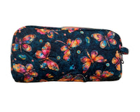 A quilted zippered pouch with a colorful butterfly pattern on a dark navy background