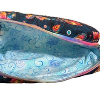 A zippered fabric pouch shown open, with a dark navy exterior featuring a colorful butterfly print and a light blue patterned lining. 
