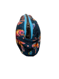 A medium quilted fabric zip pouch with a colorful floral pattern in pink, orange, and yellow on a dark navy background, standing upright 