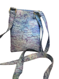 A fabric shoulder bag with a blue, purple, and white crackle pattern.