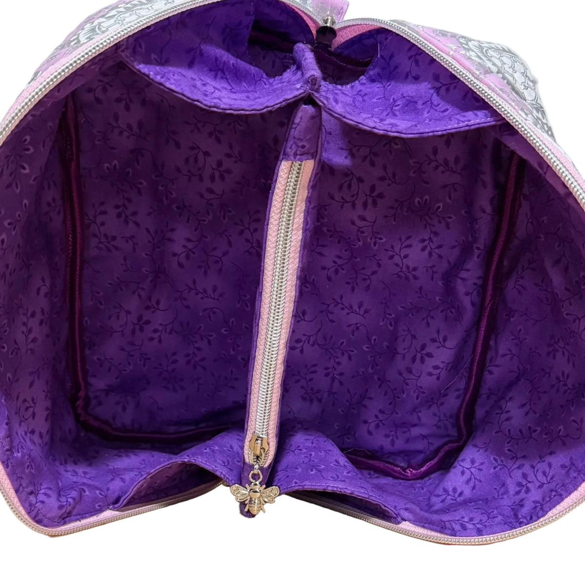 Open Haven Pouch in Frosted Orchid showing purple vine-print lining and zippered center divider