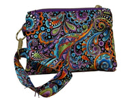 Back of the Carnival Swirl Swing Mini wristlet with a wrist strap in colorful paisley fabric on black