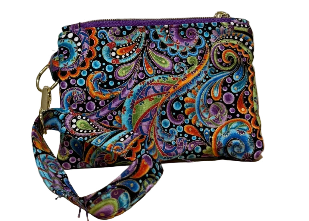 Back of the Carnival Swirl Swing Mini wristlet with a wrist strap in colorful paisley fabric on black