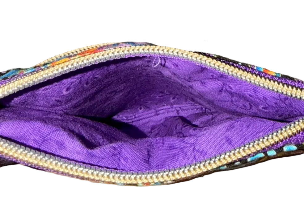 Inside of the Carnival Swirl Swing Bag Mini showing the bright purple lining