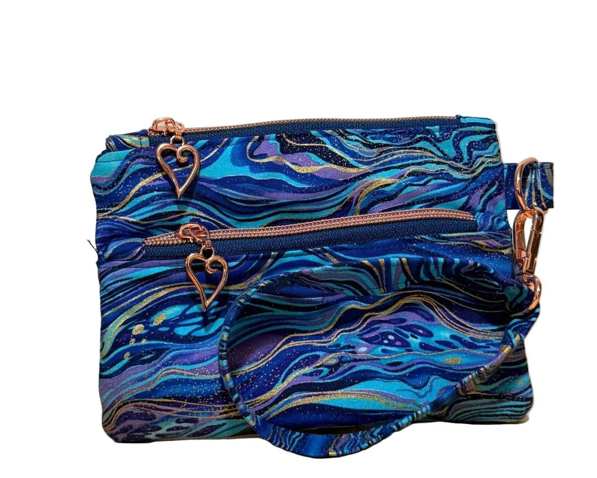Handmade Gilded Tide Swing Mini wristlet in blue, teal, and purple marble fabric with gold veins, front view