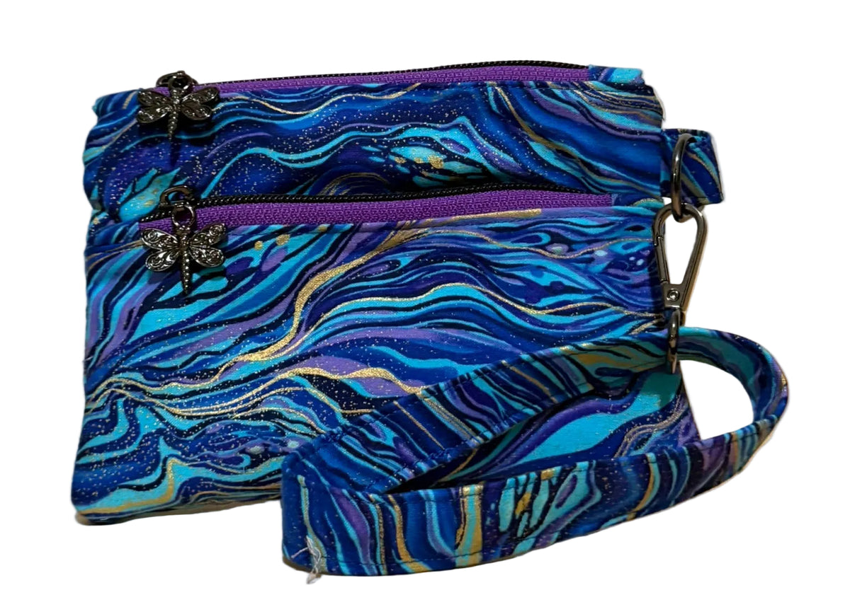 Handmade Gilded Tide Swing Mini wristlet in blue, teal, and purple marble fabric with gold veins, front view