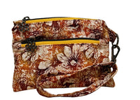 Rust Blossom Swing Bag Mini wristlet with two front zip compartments and a wrist strap in rust and cream autumn floral fabric