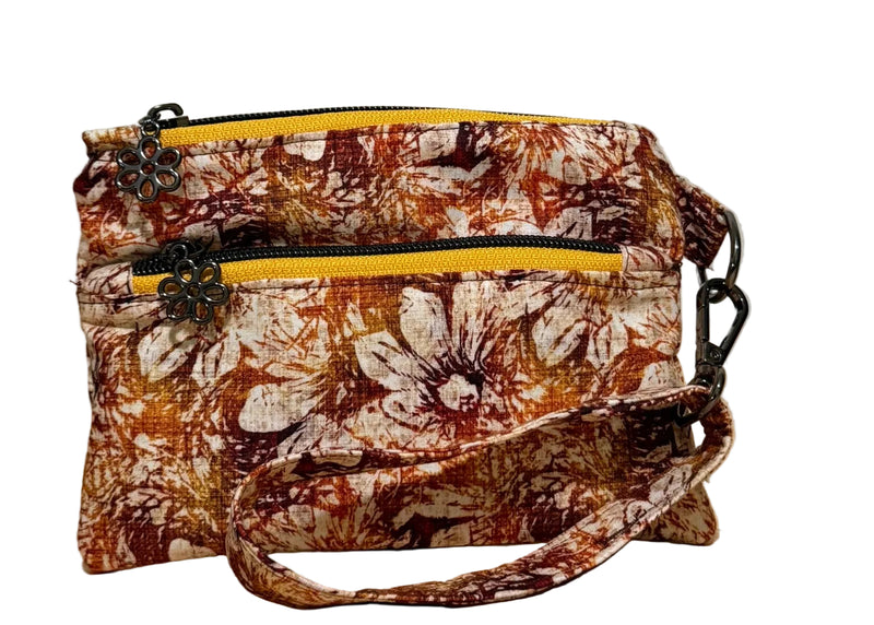 Rust Blossom Swing Bag Mini wristlet with two front zip compartments and a wrist strap in rust and cream autumn floral fabric