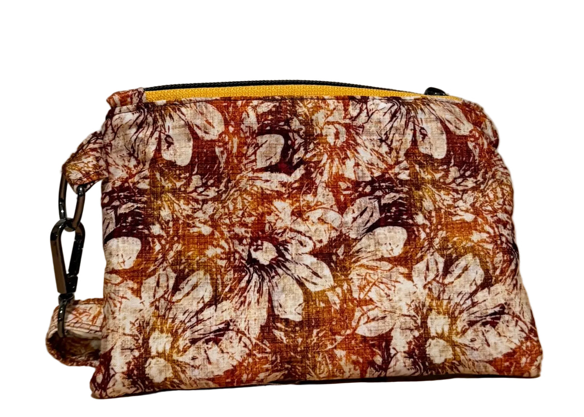 Back of the handmade Rust Blossom Swing Mini wristlet in rust, amber, and cream floral fabric