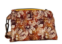 Back of the handmade Rust Blossom Swing Mini wristlet in rust, amber, and cream floral fabric