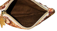 Inside of the Rust Blossom Swing Bag Mini showing the brown lining and open zip compartment