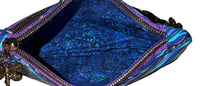 Inside of the Gilded Tide Swing Mini wristlet showing the blue floral lining and zip compartment